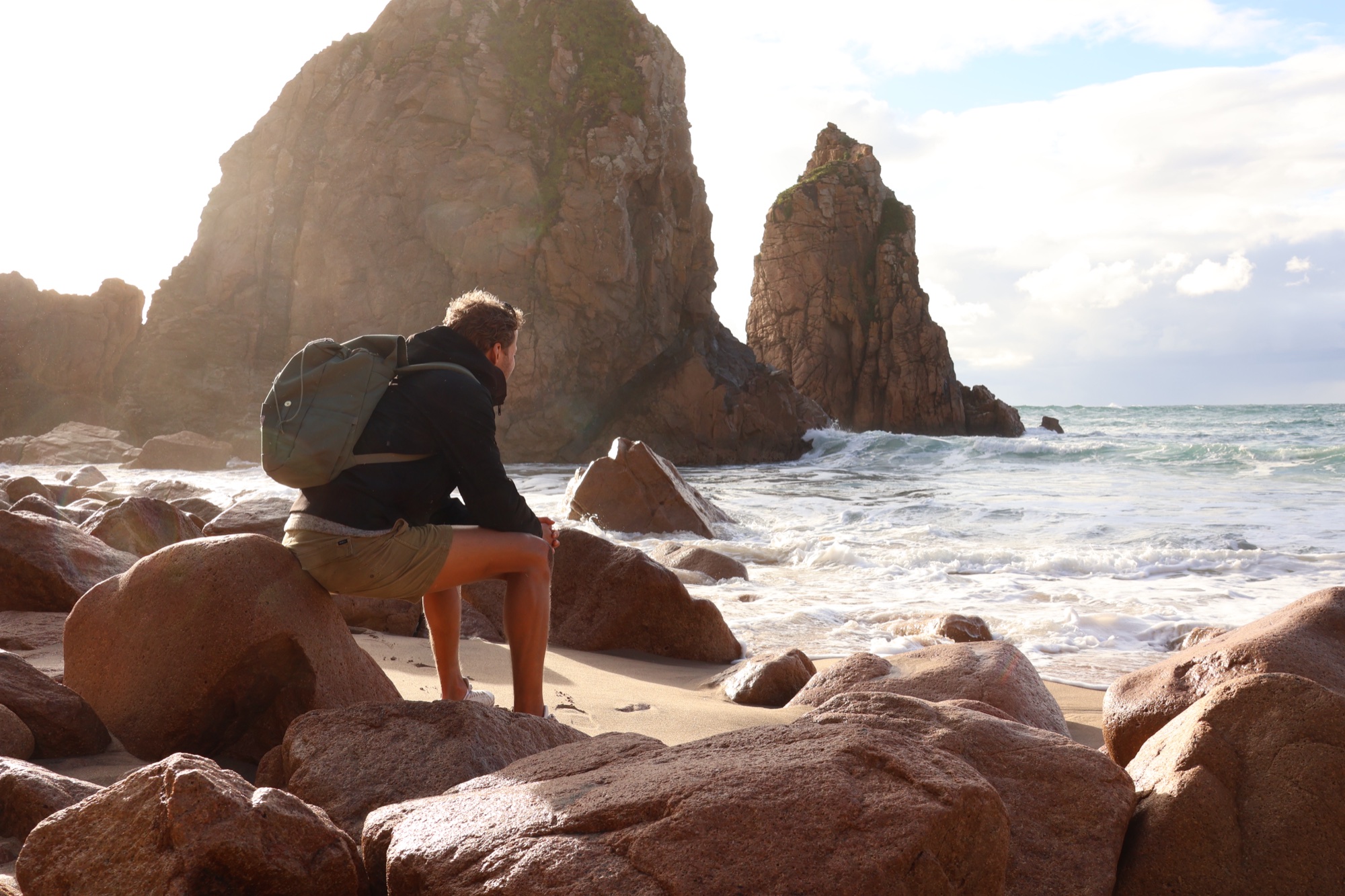 Watching the ocean from the rocks at golden hour