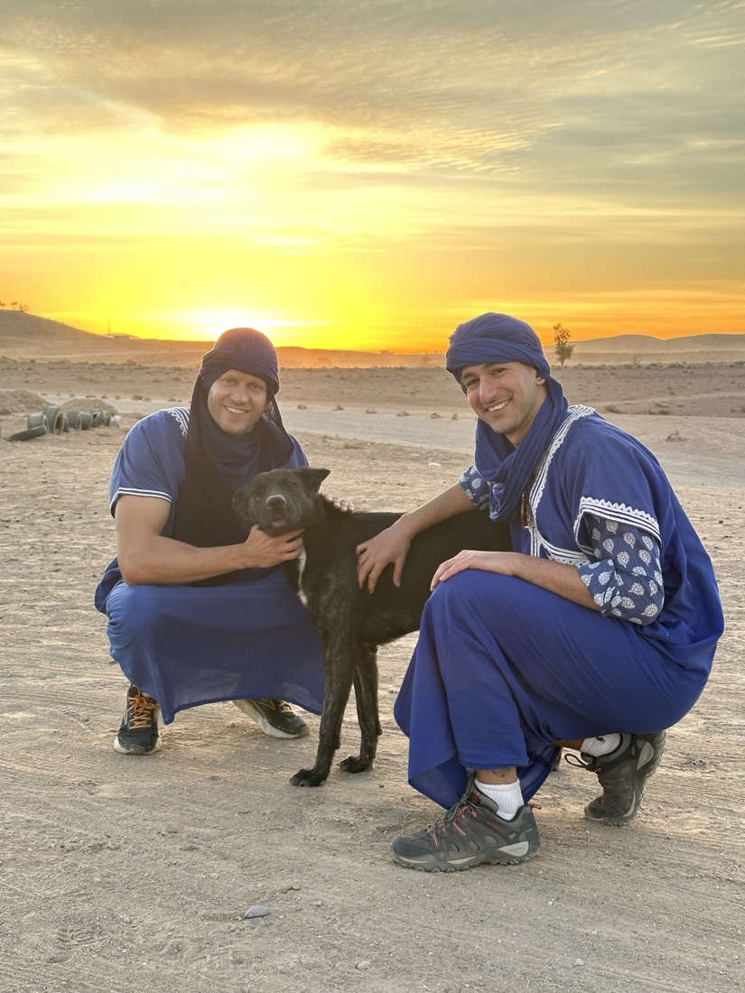 Two friends and the dog at sunset